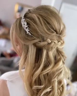 Boho bridal half-up style with a soft braid and loose blonde waves