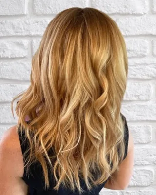 Dimensional strawberry blonde hair color with warm golden tones