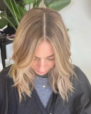 Shoulder-length blonde lob haircut styled with soft texture